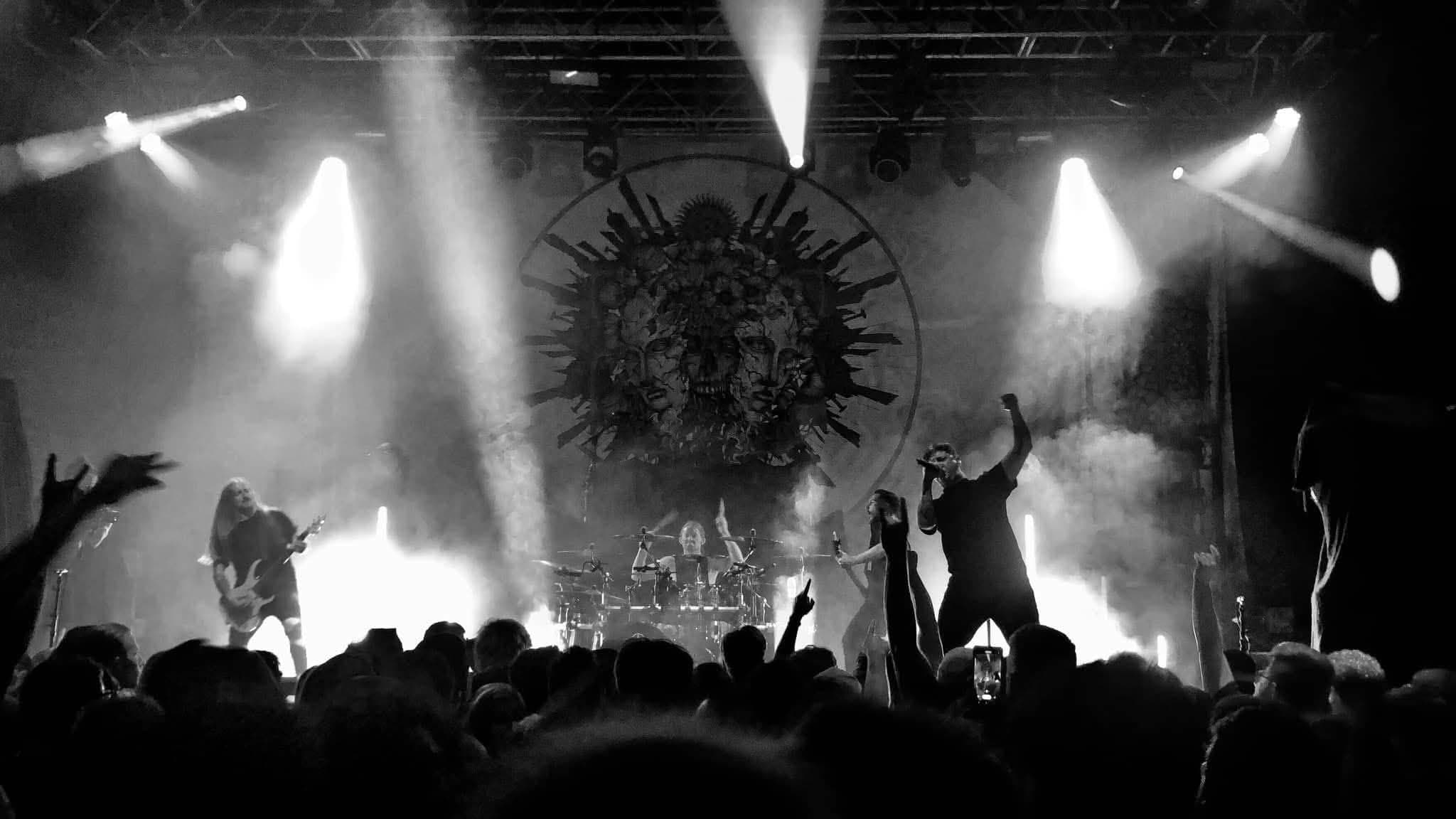 A band performing live under stage lights